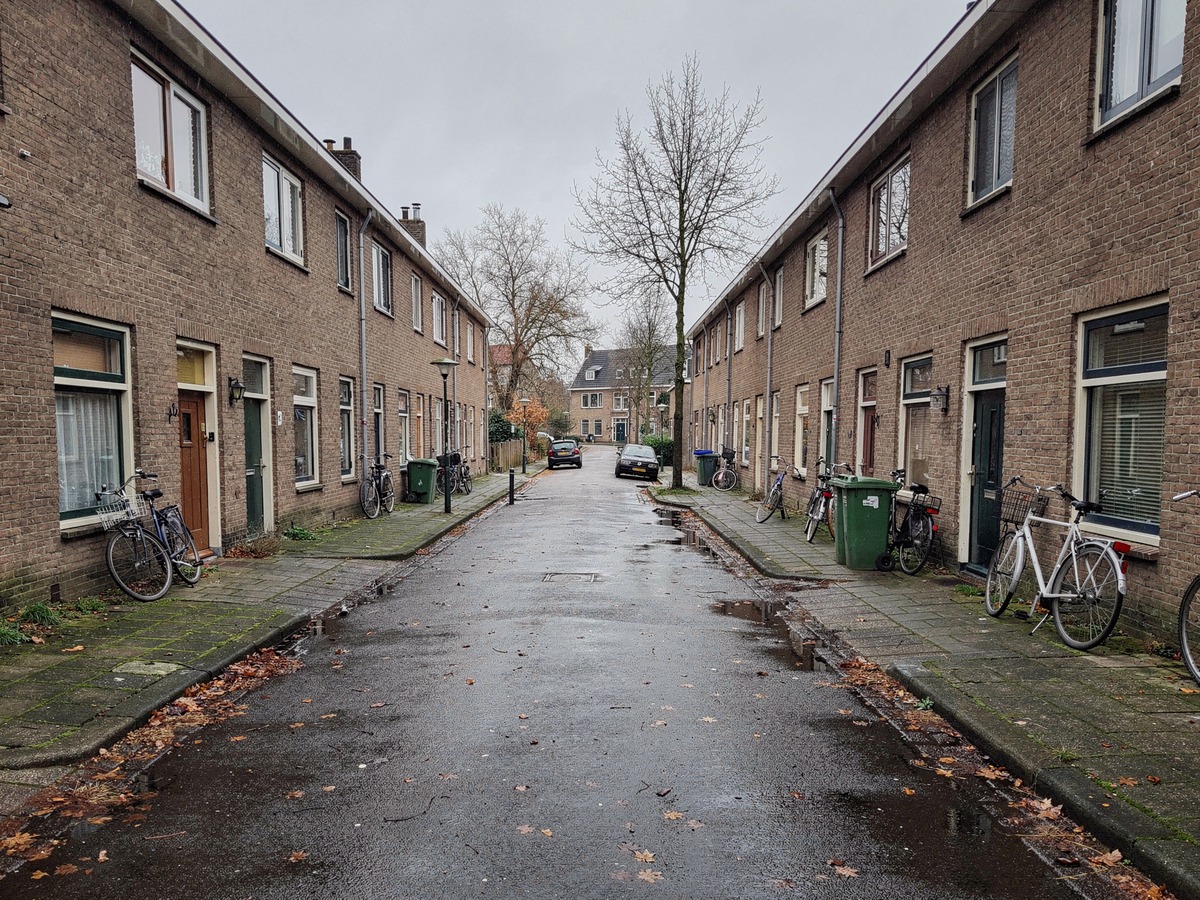 Ordinary Dutch residential street with brick terraced houses and parked bicycles