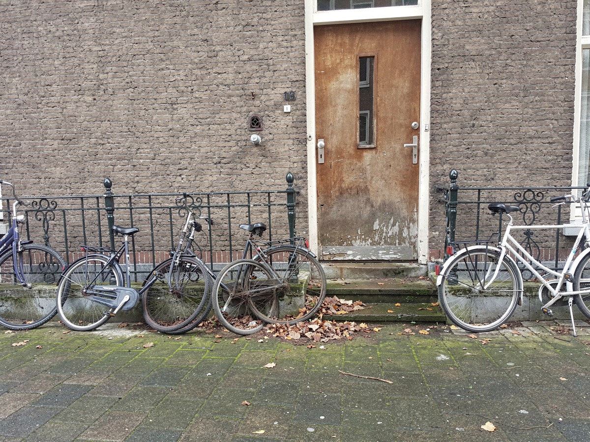 Shared front door of a Dutch student house with bicycles leaning against the railing